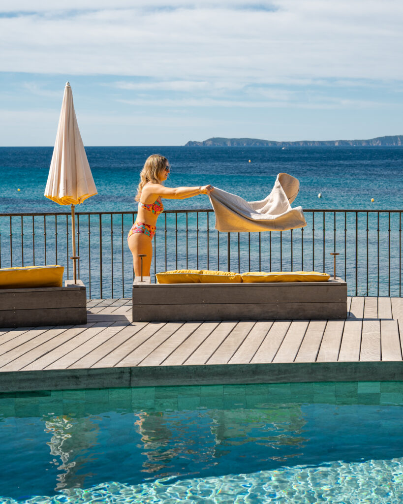 Installation d'une jeune femme à la piscine d'un hôtel vue mer